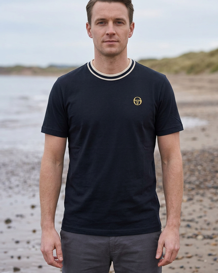 Male model wearing the reference T-shirt on a UK beach in autumn