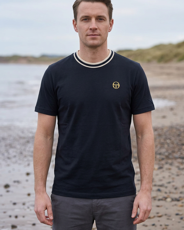 Male model wearing the reference T-shirt on a UK beach in autumn