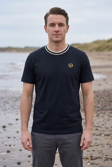 Male model wearing the reference T-shirt on a UK beach in autumn