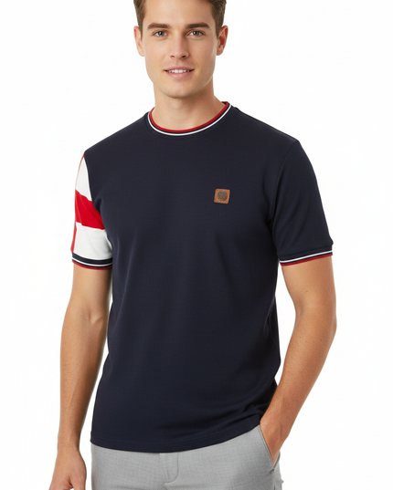 Male model wearing Trojan navy tee with red and white sleeve panel on one arm