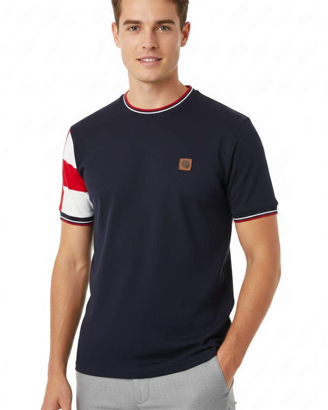 Male model wearing Trojan navy tee with red and white sleeve panel on one arm
