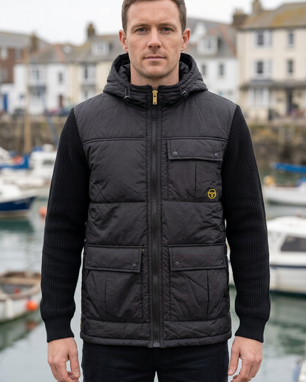 White male model wearing the jacket in an autumn British coastal town