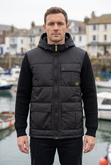 White male model wearing the jacket in an autumn British coastal town