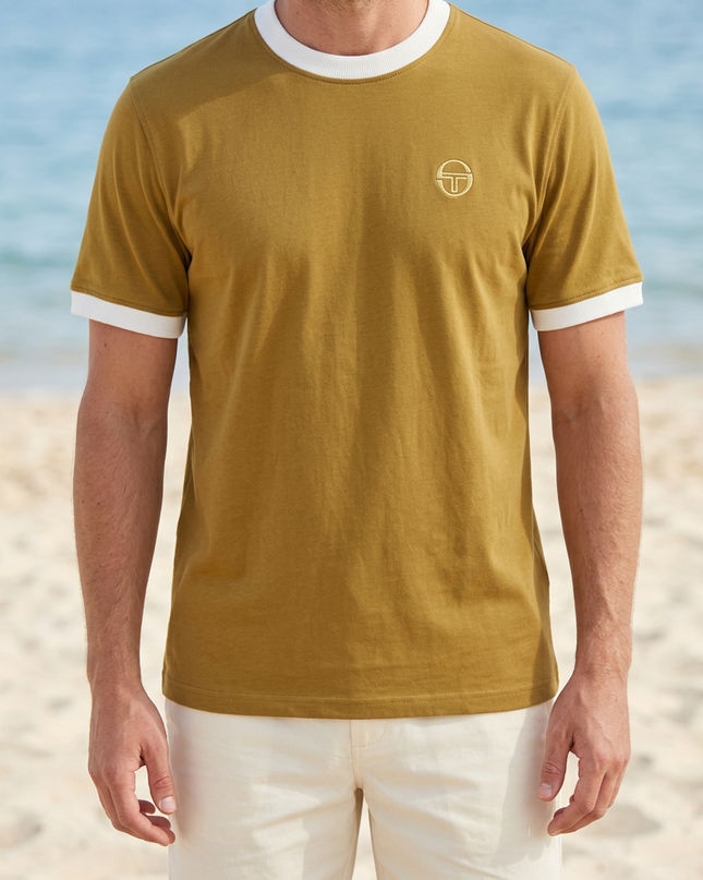 White male model wearing the reference T-shirt on a summer beach