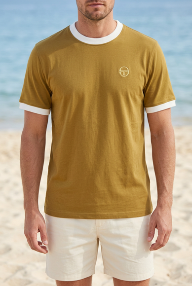 White male model wearing the reference T-shirt on a summer beach